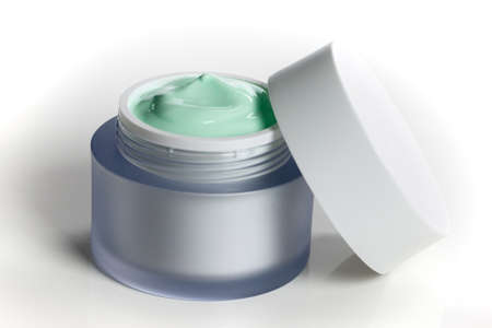 Glass jar of beauty face cream with cap. Isolated on white backgroundの写真素材