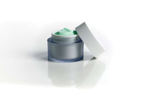 Glass jar of beauty face cream with cap. Isolated on white backgroundの写真素材
