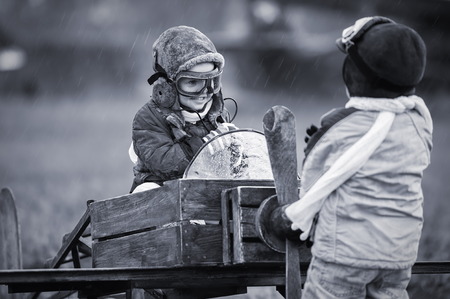 Young aviators at the airport with a homemade airplaneの写真素材