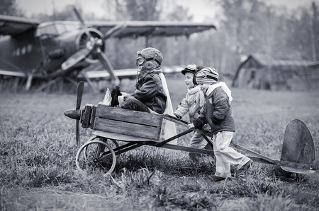 Young aviators at the airport with a homemade airplaneの写真素材