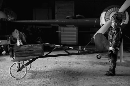 Young Aviator in a homemade aircraft in a hangar with these planesの写真素材