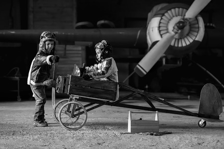 Young Aviators in a homemade aircraft in a hangar with these planesの写真素材