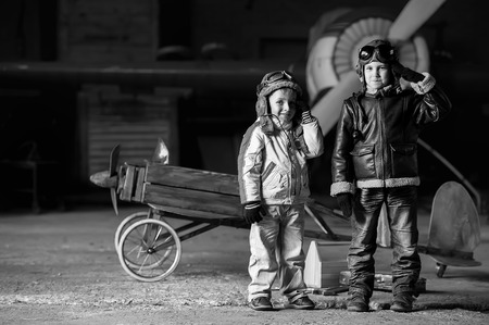 Young aviators in homemade aircraft in a large hangarの写真素材