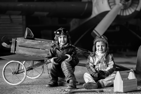 Young Aviators in a homemade aircraft in a hangar with these planesの写真素材