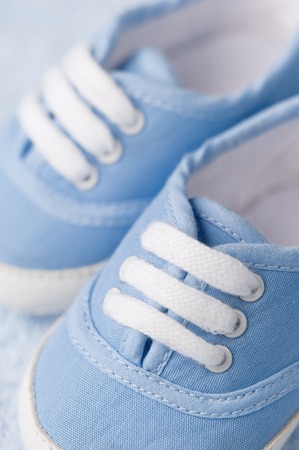 Little baby boots on a blue backgroundの写真素材