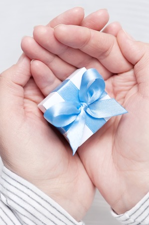 Small gift in female handsの写真素材