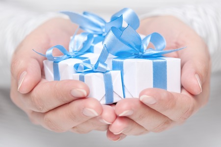 Few small gifts in female handsの写真素材