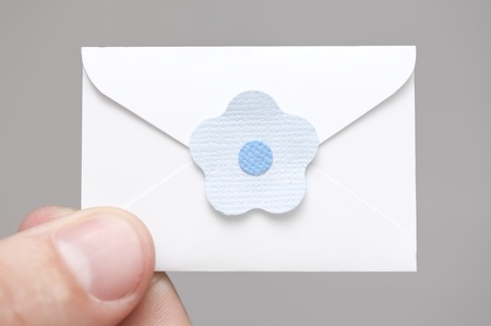 Little letter-note in the hands of menの写真素材