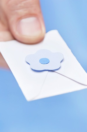 Little letter-note in the hands of menの写真素材