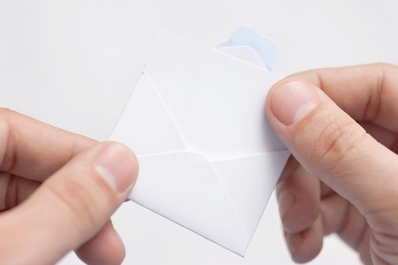 Little letter-note in the hands of menの写真素材