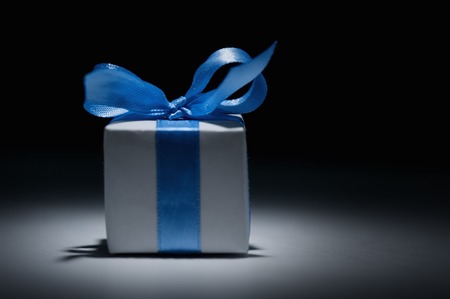 Box with gift on a black backgroundの写真素材
