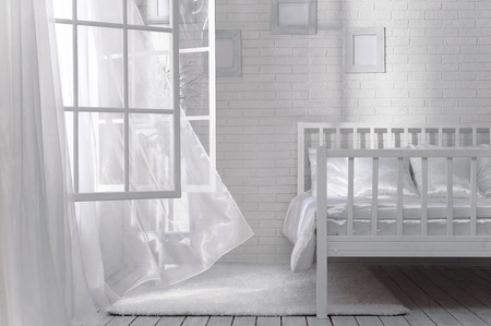 Bedroom with an open window and a light breeze on a sunny dayの写真素材