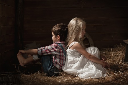 Hurt each other a boy to a girl in the hay in the barnの写真素材