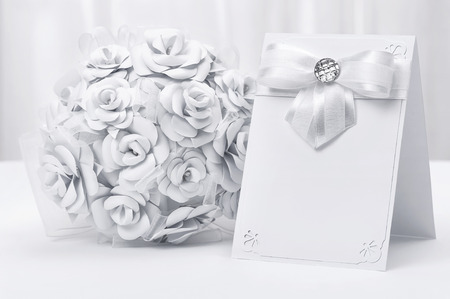 Bouquet of white roses with a card on a white backgroundの写真素材