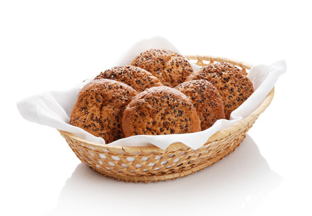 Buns with sesame in a woven basket on a white backgroundの写真素材