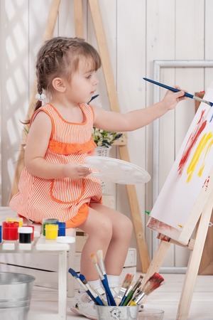 Little girl artist paints in studioの写真素材