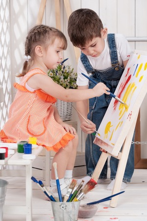 Little boy and girl painted in studioの写真素材