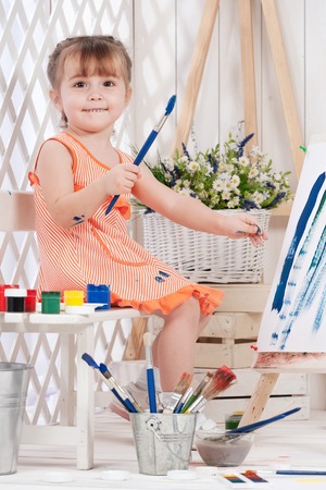 Little girl artist paints in studioの写真素材