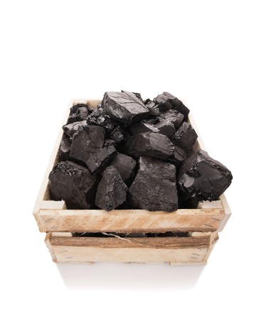 Coal in a wooden box on a white backgroundの写真素材