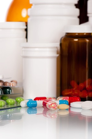 Different medical bottles and tablets on white backgroundの写真素材