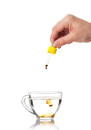 Pipette in a hand of the person on a white backgroundの写真素材