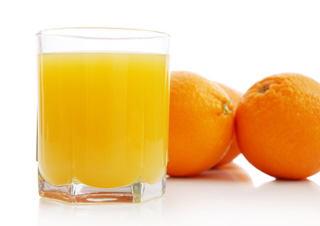 Orange juice and oranges on a white background の写真素材