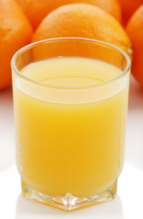 Orange juice and oranges on a white background の写真素材