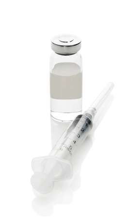 Syringe and vial with a medicine on a white backgroundの写真素材