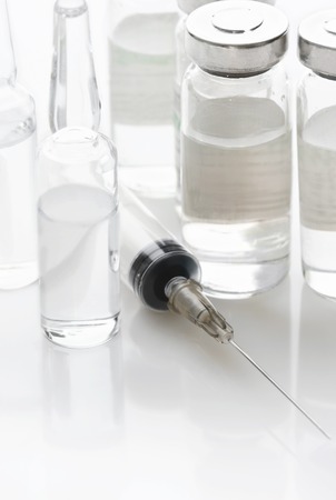 Syringe and vials with a medicine on a white backgroundの写真素材