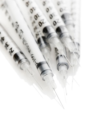 Heap insulinic syringes on a white backgroundの写真素材
