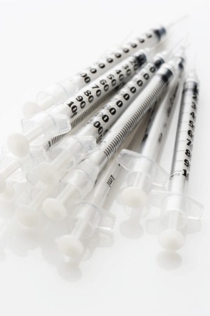 Heap insulinic syringes on a white backgroundの写真素材