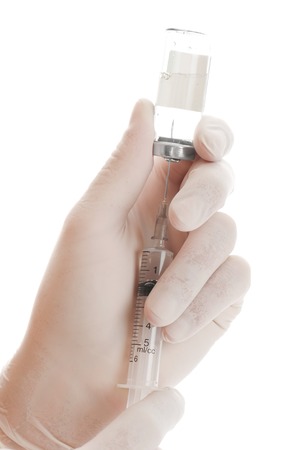 Filling of a syringe by a medicine from vial the person in glovesの写真素材