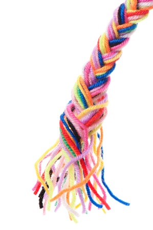 The color strings of a yarn connected in plait on a white backgroundの写真素材