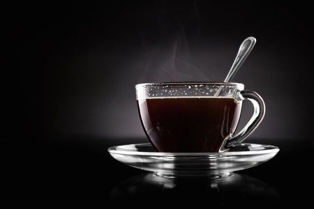 Cup of hot coffee on a black backgroundの写真素材