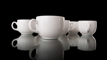 Heap of the white cups, isolated on blackの写真素材