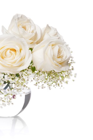 White roses in a vase with water on a white backgroundの写真素材