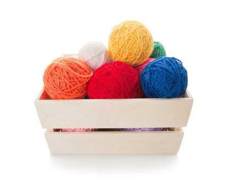 Clews the yarn for knitting in the wooden box, isolated on whiteの写真素材