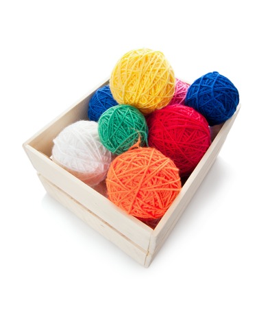 Clews the yarn for knitting in the wooden box, isolated on whiteの写真素材