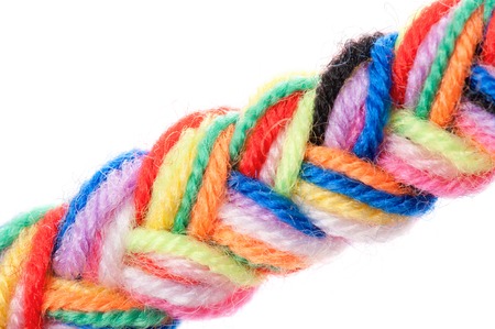 The color strings of a yarn connected in plait on a white backgroundの写真素材