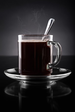 Cup of hot coffee on a black backgroundの写真素材