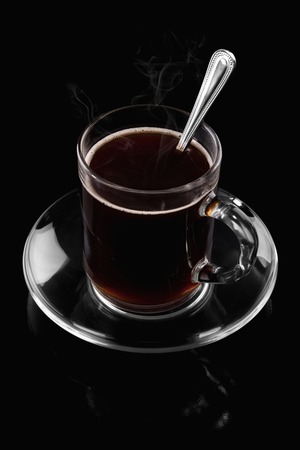 Cup of hot coffee on a black backgroundの写真素材