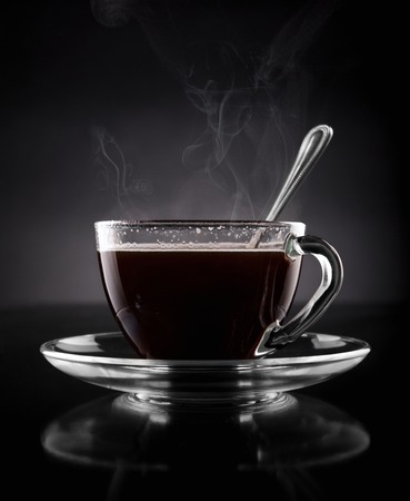 Cup of hot coffee on a black backgroundの写真素材