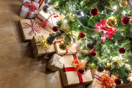 Christmas tree with glowing garland and gifts close-upの写真素材