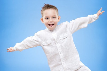Portrait of a happy boy on a blue の写真素材