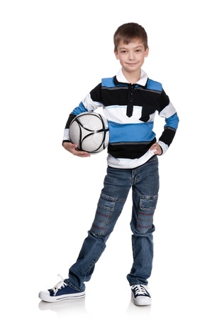 Portrait of the boy with a ball on a white backgroundの写真素材