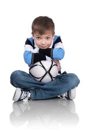 Portrait of the boy with a ball on a white backgroundの写真素材