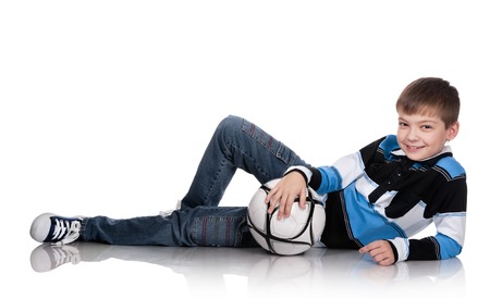 Portrait of the boy with a ball on a white backgroundの写真素材