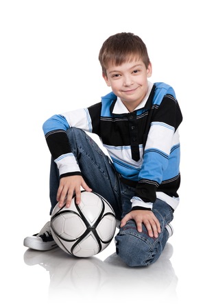 Portrait of the boy with a ball on a white backgroundの写真素材