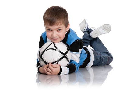 Portrait of the boy with a ball on a white backgroundの写真素材