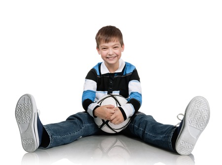 Portrait of the boy with a ball on a white backgroundの写真素材